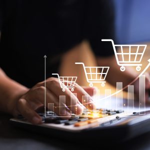Revenue graph increase concept with entrepreneur using calculator to summary cost and profit shopping cart grow up in total sale for online store